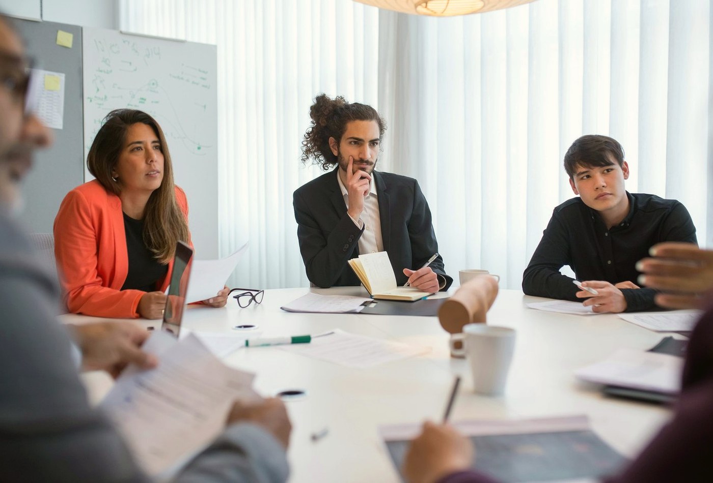 Professionals discussing questions in a meeting